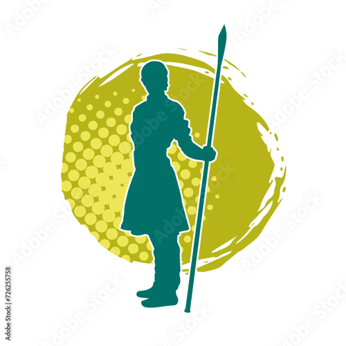 Silhouette of a wushu martial artist in action pose with a spear weapon. Silhouette of a fighter carrying a spear weapon.