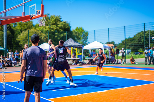 Basketball referee at a game in an outside court during summer holidays.