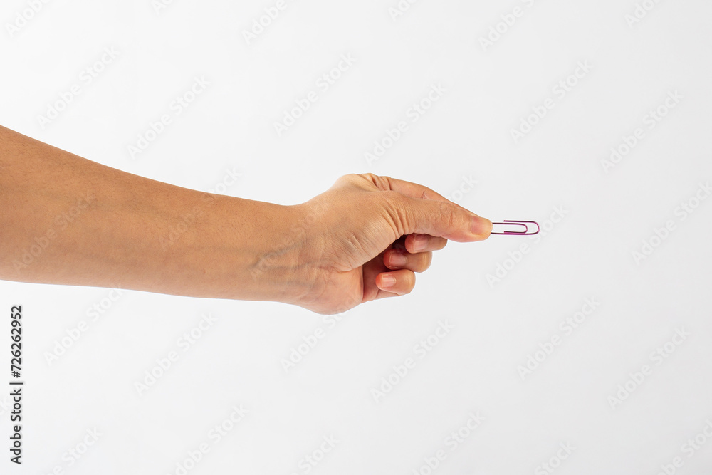 Colorful paper clip in hand isolated on white background Colorful paper clip in hand isolated on white background