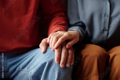 Close-up of unrecognizable woman touching mans hand to support him
