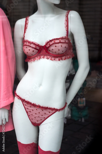 closeup of red underwear with little hearts on mannequin in a fashion store showroom 