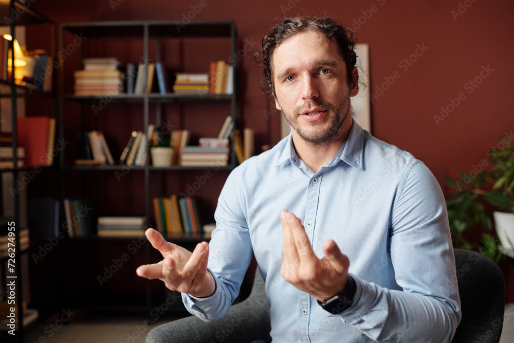 © Clique Images - POV of Caucasian man wearing light blue shirt sitting in modern office talking on video call © Clique Images - POV of Caucasian man wearing light blue shirt sitting in modern office talking on video call