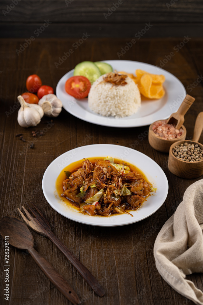 Chicken Tongseng or Tongseng ayam is an Indonesian meat or mutton stew dish in curry like soup with coconut milk, chili and sweet soy sauce. Chicken Tongseng or Tongseng ayam is an Indonesian meat or mutton stew dish in curry like soup with coconut milk, chili and sweet soy sauce.