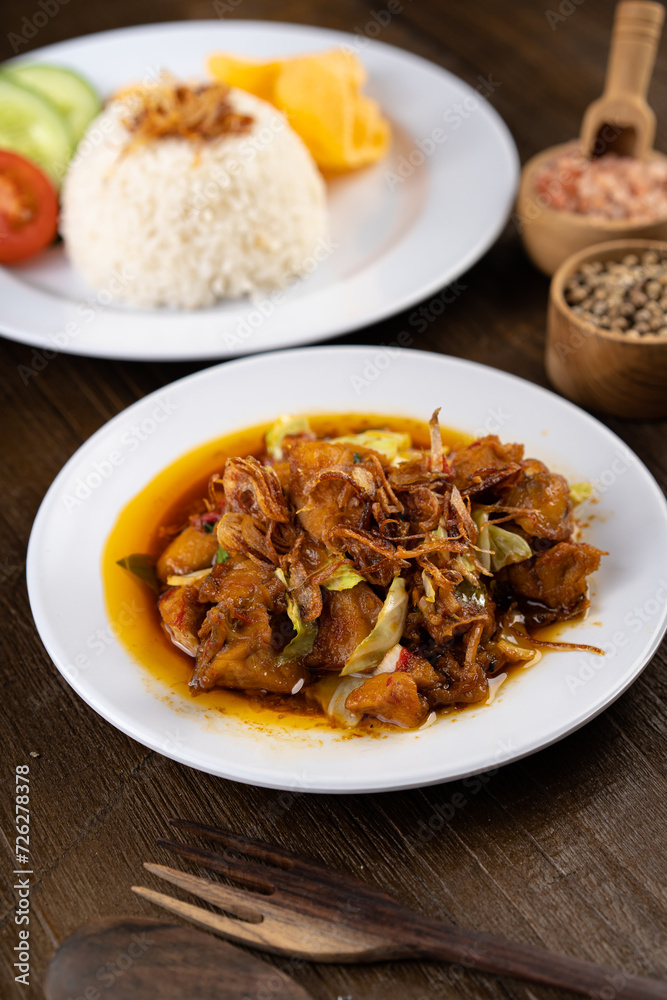 Chicken Tongseng or Tongseng ayam is an Indonesian meat or mutton stew dish in curry like soup with coconut milk, chili and sweet soy sauce. Chicken Tongseng or Tongseng ayam is an Indonesian meat or mutton stew dish in curry like soup with coconut milk, chili and sweet soy sauce.