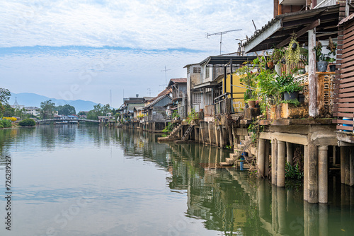 Chantaburi, Thailand - January 27, 2024 - View of houses and buildings along the river in Chantaburi, Thailand on a bright cloudy morning photo
