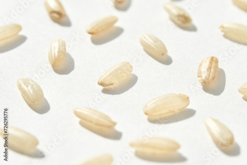 A top view captures the raw beauty of white basmati and brown rice grains. The macro closeup highlights their diverse textures, presenting a wholesome, nutritious food staple. Pattern
