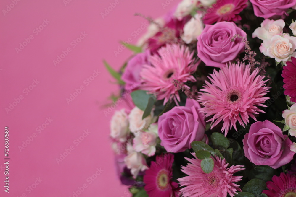 Bunch of flowers. Beautiful bouquet of fresh pink roses in full bloom on pink background, close up. Top view. Valentine day or Mother day, love concept. Stock photo Bunch of flowers. Beautiful bouquet of fresh pink roses in full bloom on pink background, close up. Top view. Valentine day or Mother day, love concept. Stock photo