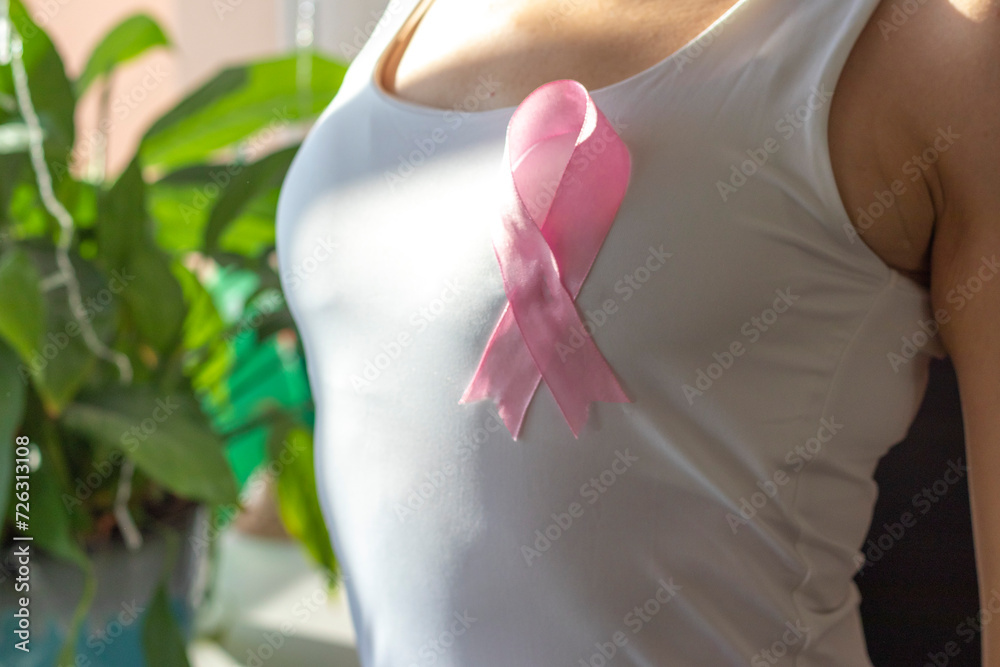custom made wallpaper toronto digitalShot of the woman against the white wall in the white top with pink ribbon, as a symbol of a breast cancer awareness. Concept