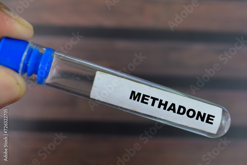 Methadone - Test with blood sample on wooden background. Healthcare or medical concept
