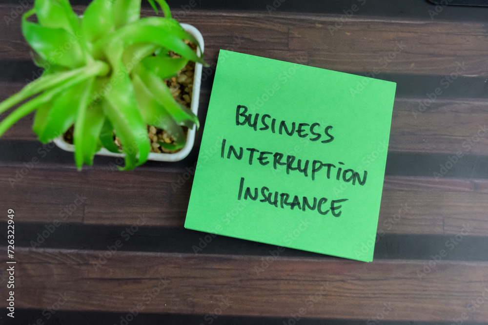 Naklejka premium Concept of Business Interruption Insurance write on sticky notes isolated on Wooden Table.