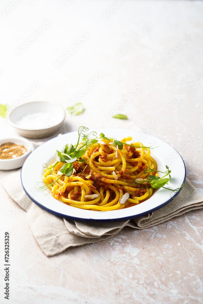 Pasta with red pesto and almond