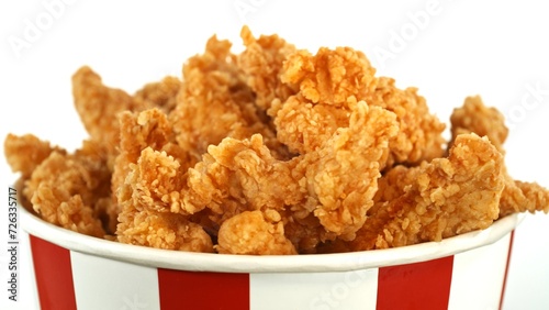 Fried Chicken Pieces in Paper Bucket, Isolated on White Background. Concept of Junk Food.