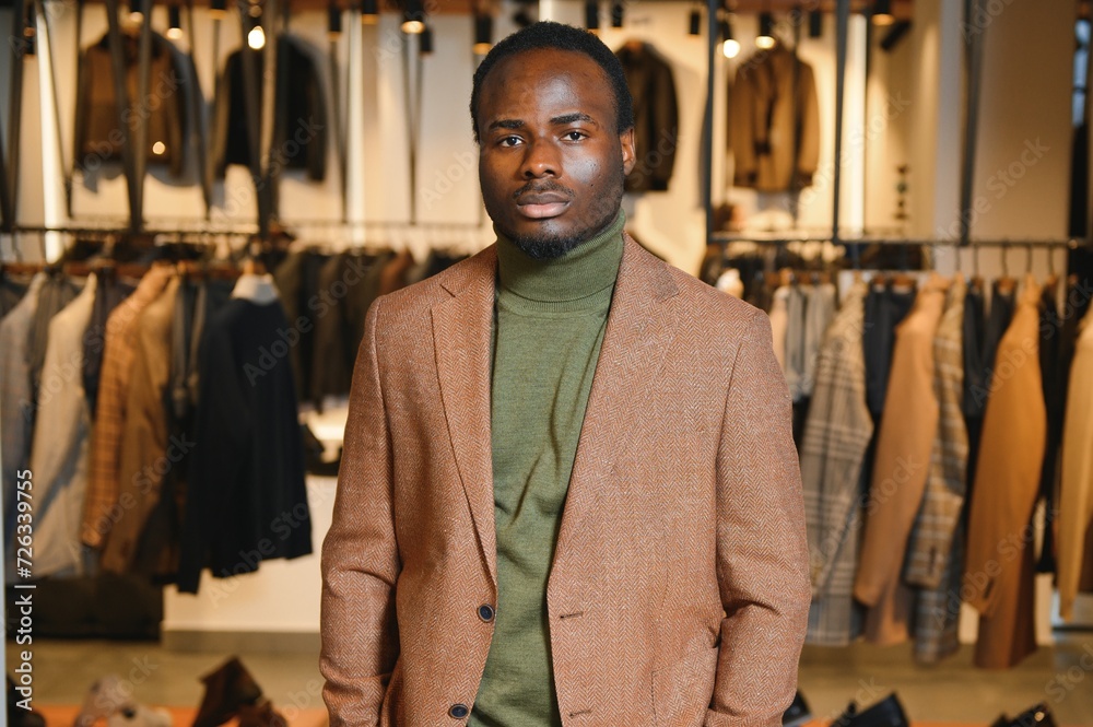 A handsome young african gentleman buying an elegant suit A handsome young african gentleman buying an elegant suit