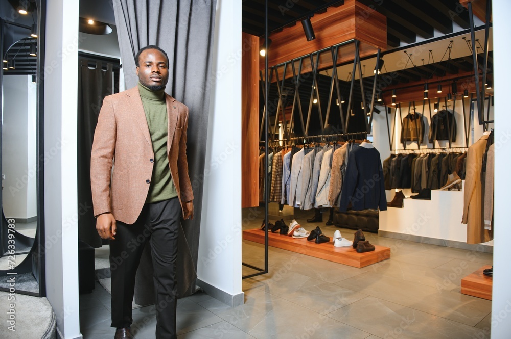 African businessman in elegant classic suit in a premium men's clothing store African businessman in elegant classic suit in a premium men's clothing store