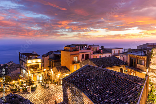 amazing evening view from mountain town to beautiful italian town with roofs and biuldings and scenic water of a sea gulf with amazing cloudy sky on background photo