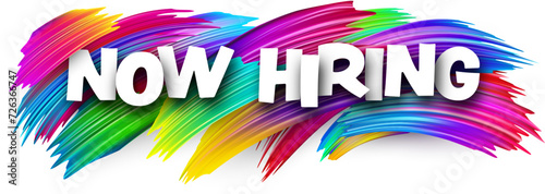 Now hiring paper word sign with colorful spectrum paint brush strokes over white.