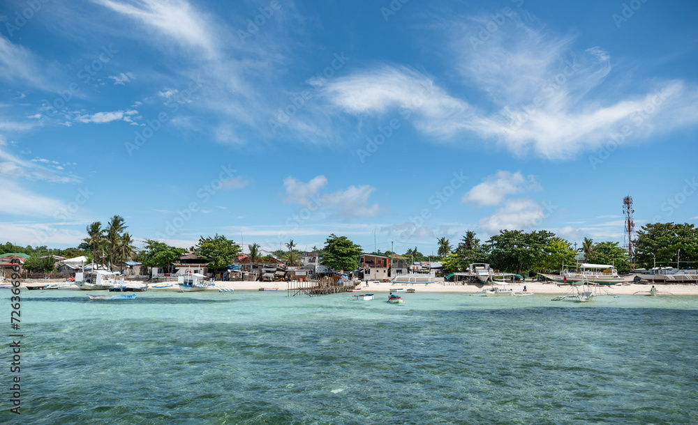 Beach in Malapascua with boats and sandy beach. Clear Blue Sky in Background. Beach in Malapascua with boats and sandy beach. Clear Blue Sky in Background.