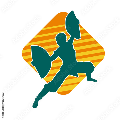 Silhouette of a slim female doing martial art pose. Silhouette of a martial art woman in action pose.