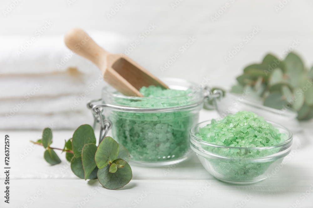 Cosmetic sea salt with aroma and eucalyptus extract on a textured wooden background with branches of fresh aromatic eucalyptus.Spa concept. Bath salt. Close-up. Space for text.Body care.copy space Cosmetic sea salt with aroma and eucalyptus extract on a textured wooden background with branches of fresh aromatic eucalyptus.Spa concept. Bath salt. Close-up. Space for text.Body care.copy space