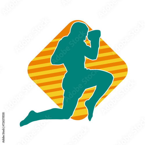 Silhouette of a kickboxer athlete in action pose. Silhouette of a sporty man doing kicking pose.
