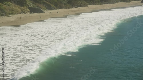 Slow motion of powerful wave breaking on shore of Port Orford Bay photo