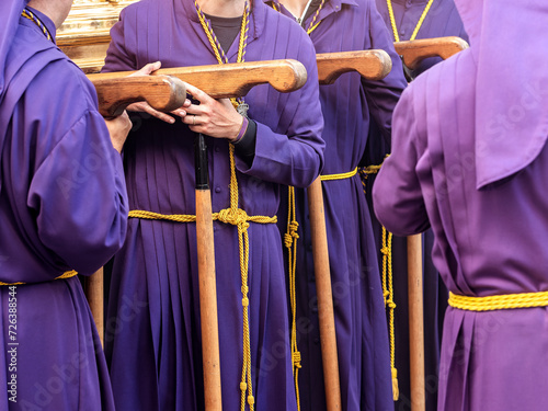 Procession Participants in Purple Robes Holding Wooden Staffs