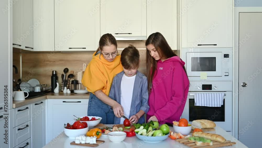 Teenage friends cook healthy food in the kitchen at home Teenage friends cook healthy food in the kitchen at home