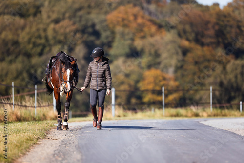 Girl rider goes riding with her horse ready to ride. © RD-Fotografie