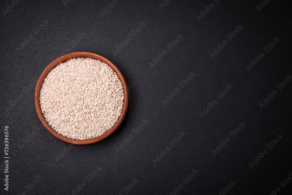 Large grains of uncooked white rice in a ceramic bowl Large grains of uncooked white rice in a ceramic bowl