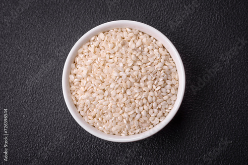 Large grains of uncooked white rice in a ceramic bowl