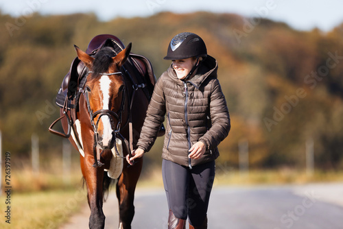 Girl rider goes riding with her horse ready to ride. © RD-Fotografie