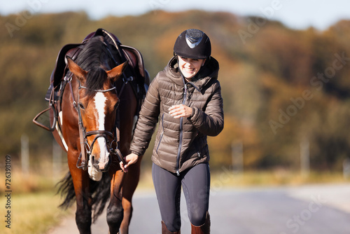 Girl rider goes riding with her horse ready to ride. © RD-Fotografie