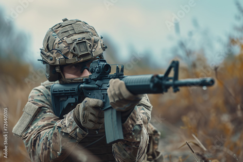 Soldier in camouflage uniform with aiming rifle take part in military training photo