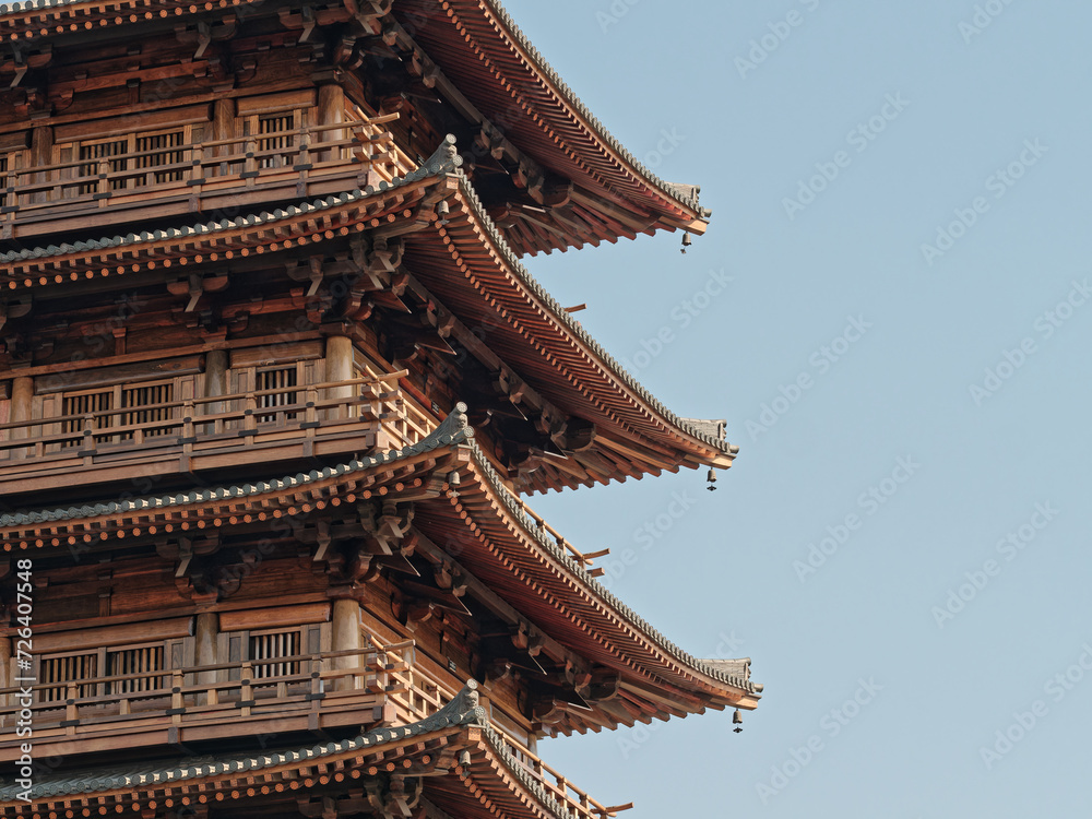 Chinese traditional eaves. The eaves of traditional temples. Beautiful Chinese traditional eaves. Close up view of Tang dynasty style pagoda, wooden structure. Chinese traditional eaves. The eaves of traditional temples. Beautiful Chinese traditional eaves. Close up view of Tang dynasty style pagoda, wooden structure.