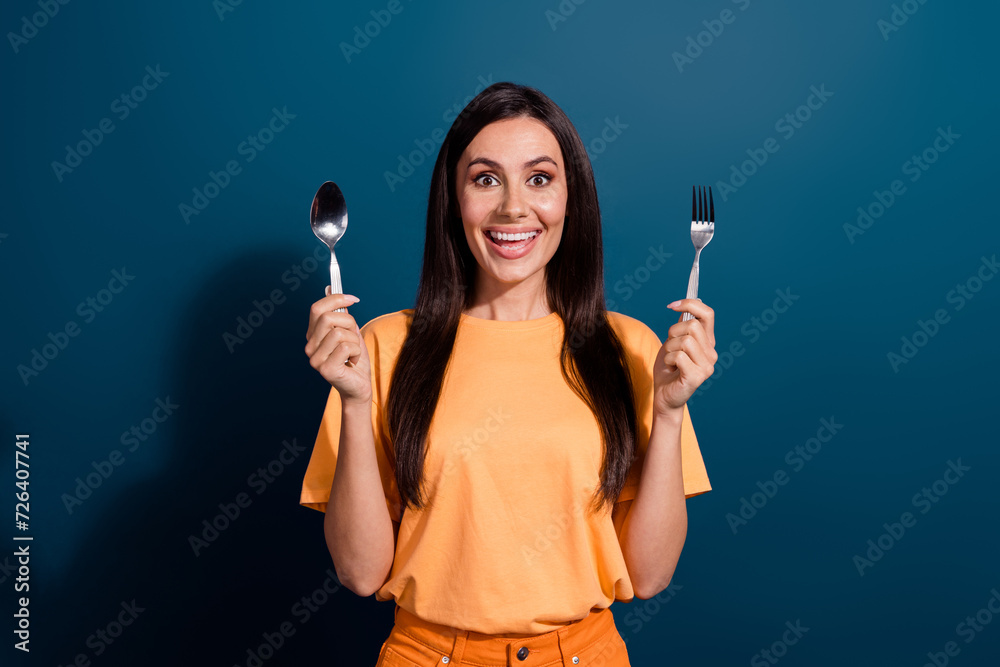 Closeup photo of positive mature woman hold fork spoon ready to eat food in best restaurant isolated over dark blue color background