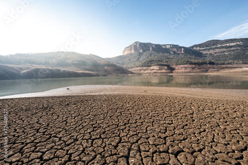 Desolate landscape of dry and broken land in the Sau reservoir, Panta de Sau, due to the greatest drought in Catalonia in history photo