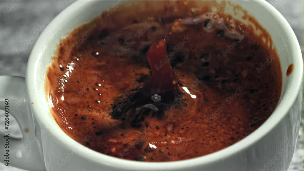 Falling drop in a cup of coffee. Filmed on a high-speed camera at 1000 fps. High quality FullHD footage Falling drop in a cup of coffee. Filmed on a high-speed camera at 1000 fps. High quality FullHD footage