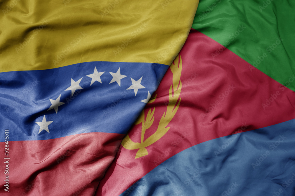 Fototapeta premium big waving national colorful flag of eritrea and national flag of venezuela . macro