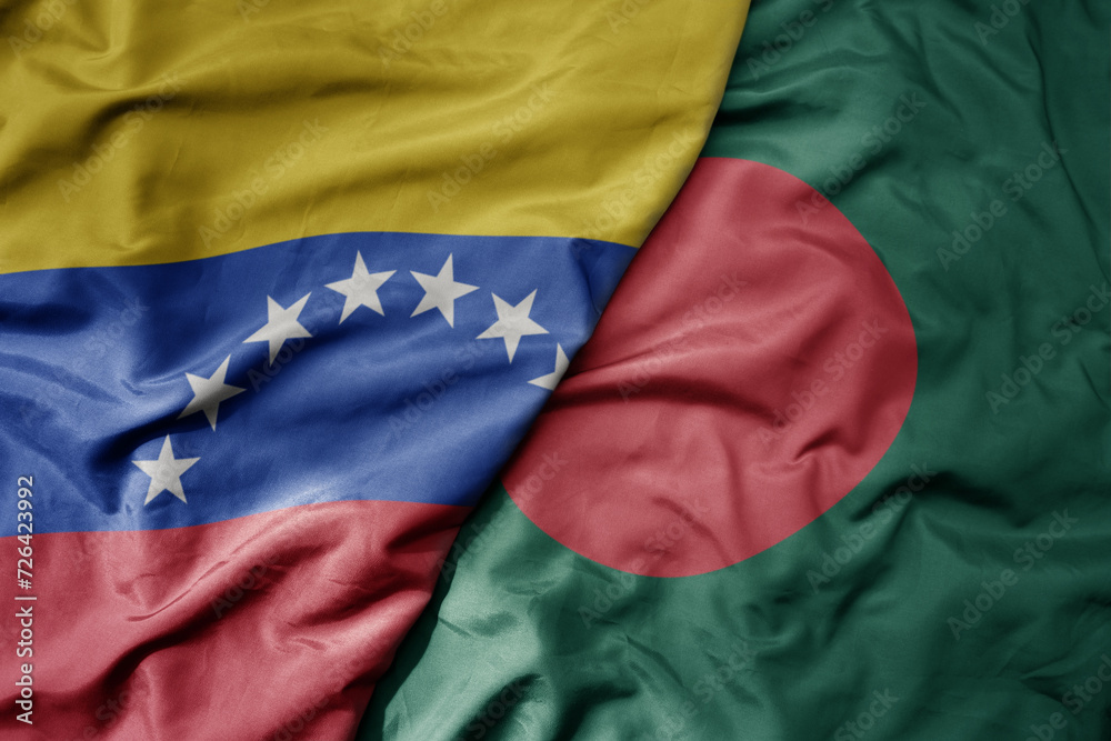 Fototapeta premium big waving national colorful flag of bangladesh and national flag of venezuela . macro