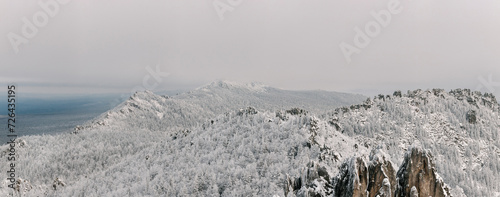 Ural mountains in winter. Wonderful wintry landscape at sunny day. Amazing view on snow covered mountains and white spruces.
