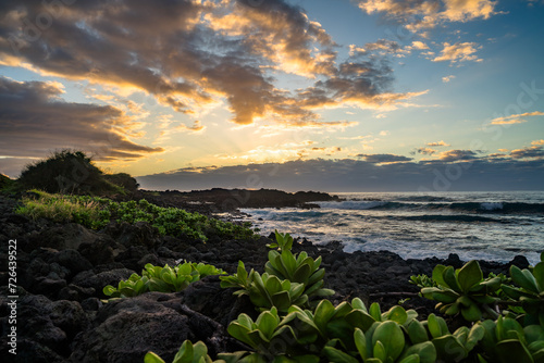 sunset with water refelction over the sea from the coast of the pacific on big island in hawaii