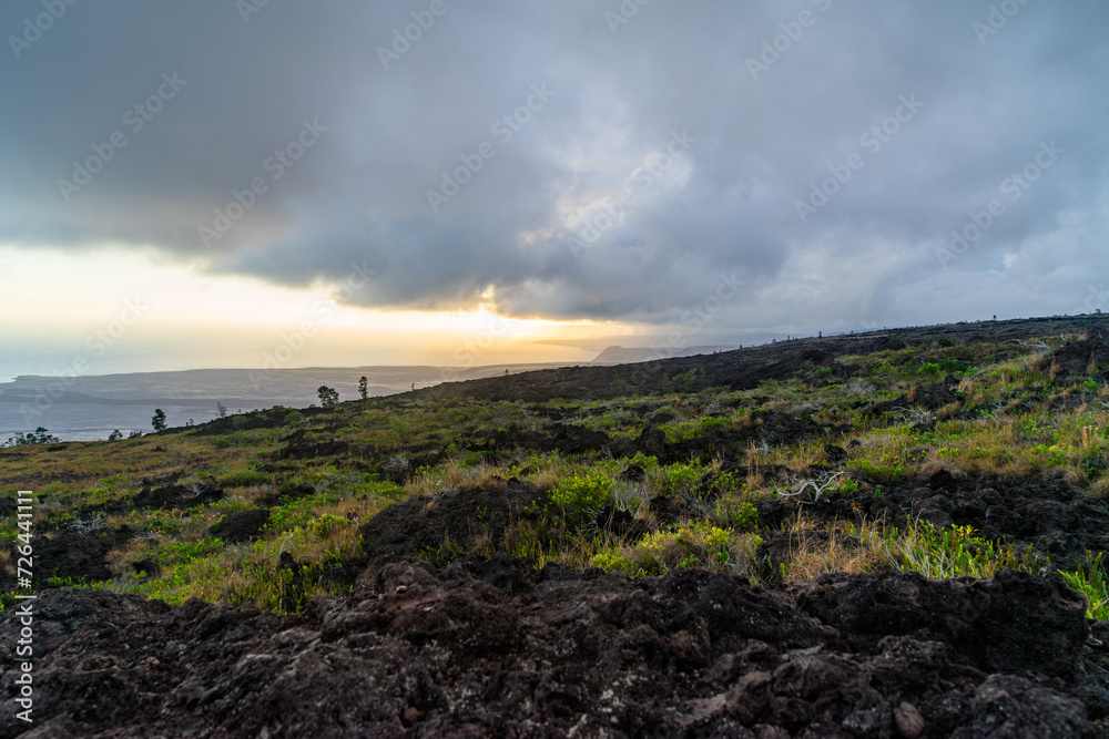 sunset over the volcanos with green plants on big island in hawaii sunset over the volcanos with green plants on big island in hawaii
