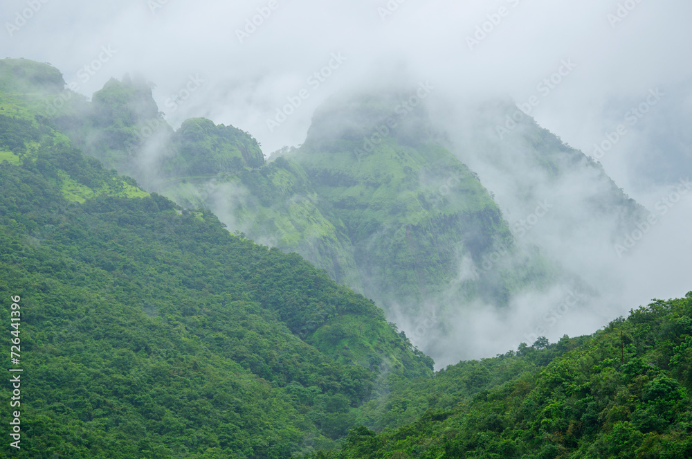 Lush green monsoon nature landscape mountains, hills, fog, clouds, Varandh Ghat, Bhor, Pune, Maharashtra, India, Asia.