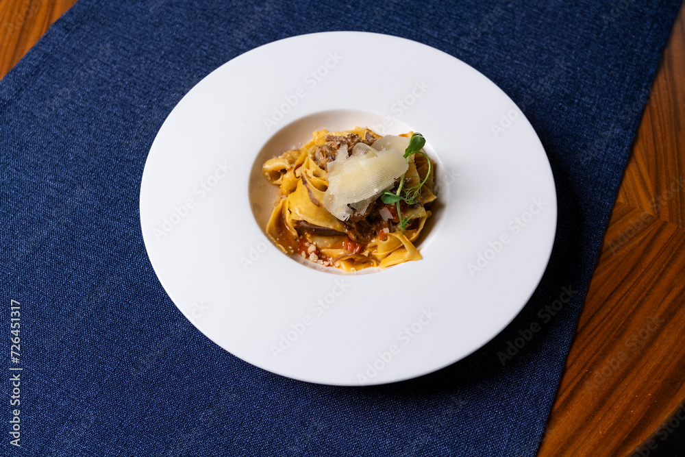 Pasta with Italian sauce served on a large plate Pasta with Italian sauce served on a large plate