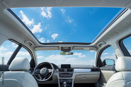 White leather seats in a modern car interior with blue sky and clouds photo