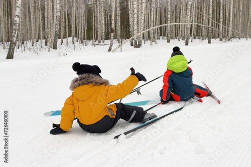 Children playing sports on a ski slope in the forest