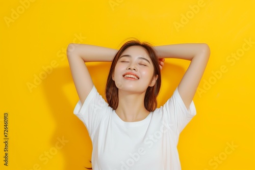 Asian woman wearing a white blank t shirt on a bold yellow background, mockup