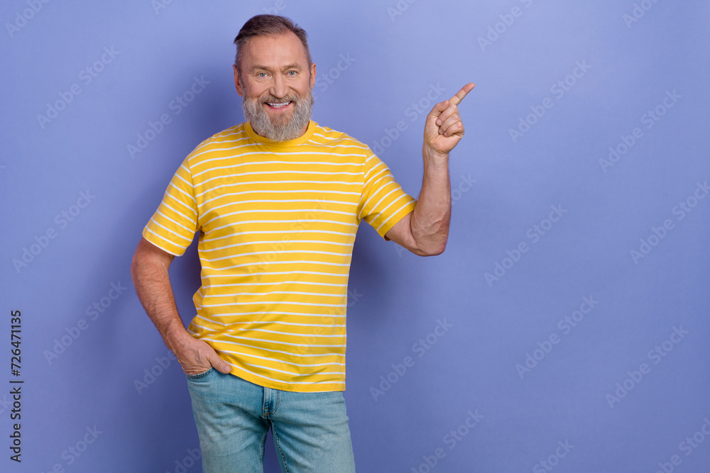 Fototapeta premium Photo of friendly positive person indicate finger empty space information ad isolated on violet color background