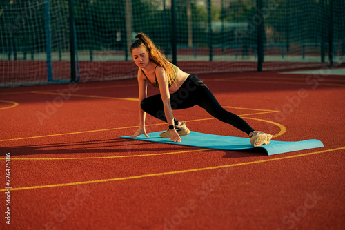 Girl doing sports outdoors on a sports ground