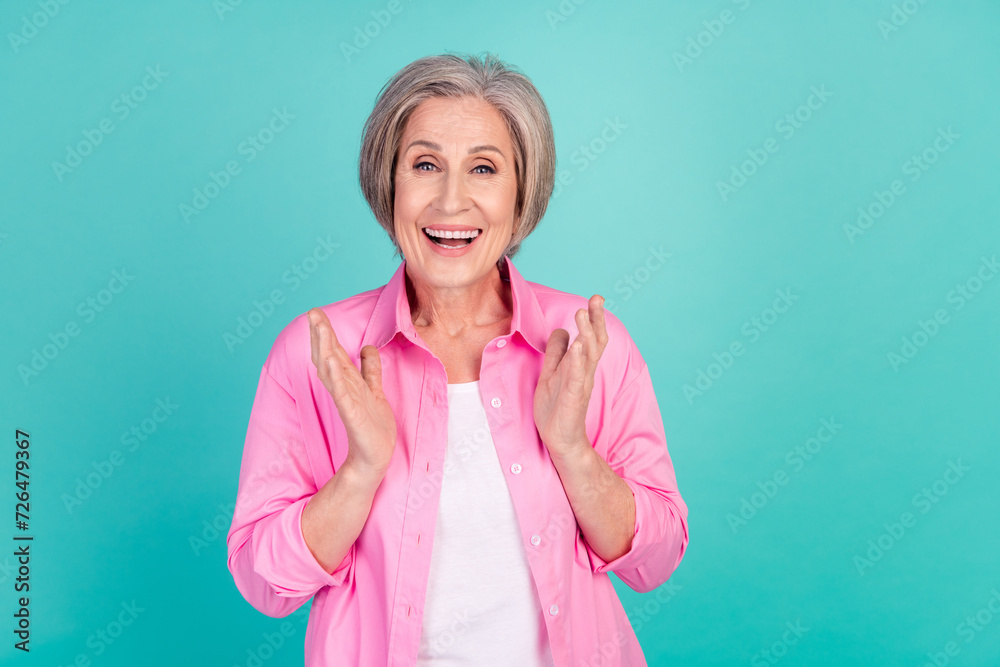 Photo portrait of friendly grandmother experienced business woman applauding her colleagues isolated on aquamarine color background Photo portrait of friendly grandmother experienced business woman applauding her colleagues isolated on aquamarine color background